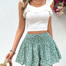 VCAY Shorts de pierna ancha para mujeres con cintura alta de estilo de vacaciones, corte holgado, cinturon anudado y estampado floral pequeno.