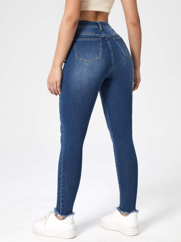 Essnce Jeans ajustados con lavado rasguno de gato bajo crudo