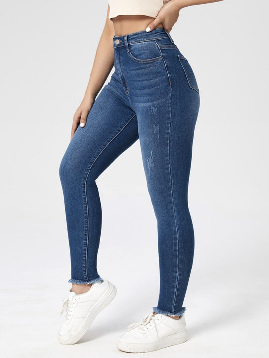 Essnce Jeans ajustados con lavado rasguno de gato bajo crudo