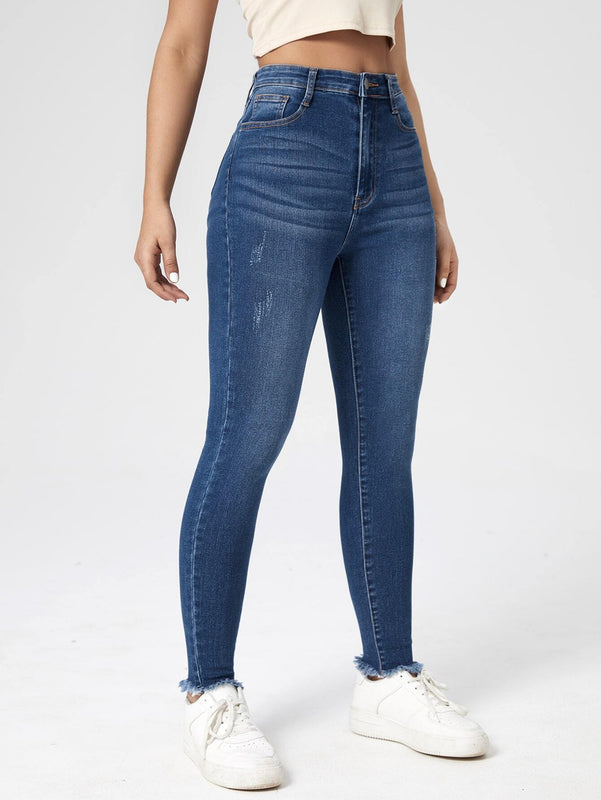 Essnce Jeans ajustados con lavado rasguno de gato bajo crudo
