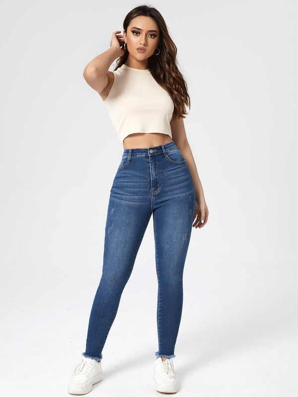 Essnce Jeans ajustados con lavado rasguno de gato bajo crudo