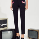 Pantalones con estampado de mariposa con abertura