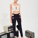 Pantalones con estampado de mariposa con abertura