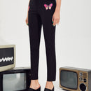 Pantalones con estampado de mariposa con abertura