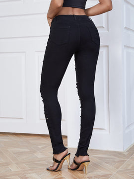 Jeans ajustados desgarro con cuenta de perla