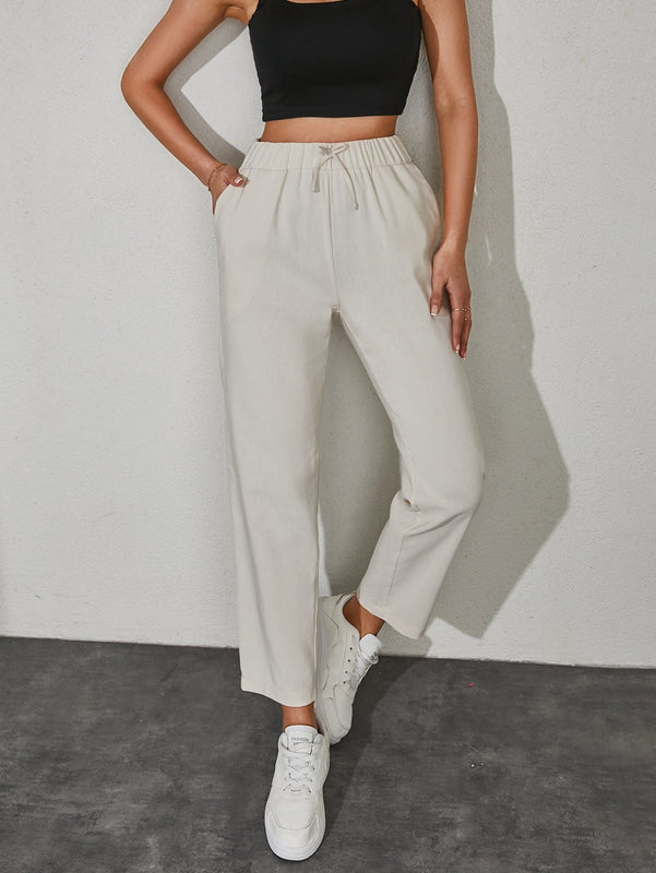 Pantalones unicolor con bolsillo oblicuo de cintura con cordon