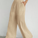 Pantalones sueltos de pierna ancha de color solido para mujer con dobladillo fluido, estilo casual