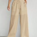 Pantalones sueltos de pierna ancha de color solido para mujer con dobladillo fluido, estilo casual