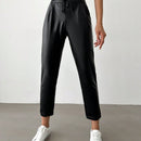 Pantalones largos de tela metalica con nudo frontal para mujer