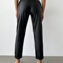 Pantalones largos de tela metalica con nudo frontal para mujer