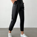 Pantalones largos de tela metalica con nudo frontal para mujer