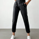 Pantalones largos de tela metalica con nudo frontal para mujer