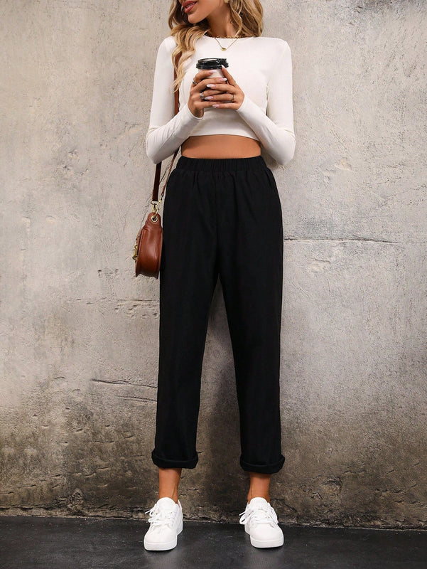 Pantalones unicolor con bolsillo oblicuo de cintura elastica