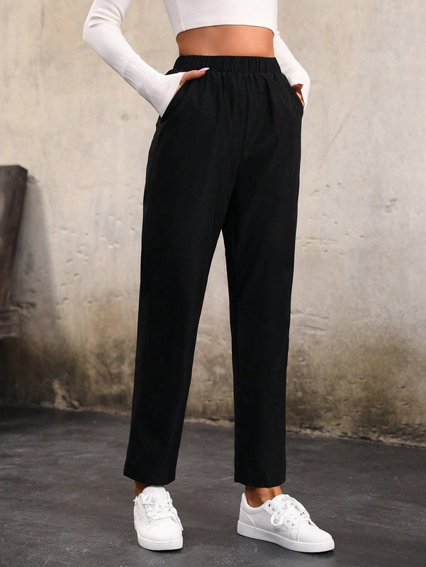 Pantalones unicolor con bolsillo oblicuo de cintura elastica