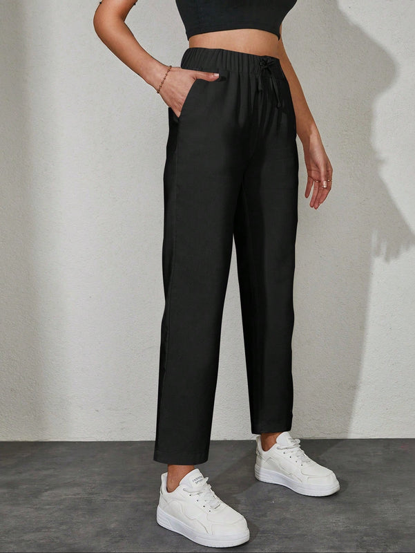 Pantalones unicolor con bolsillo oblicuo de cintura con cordon