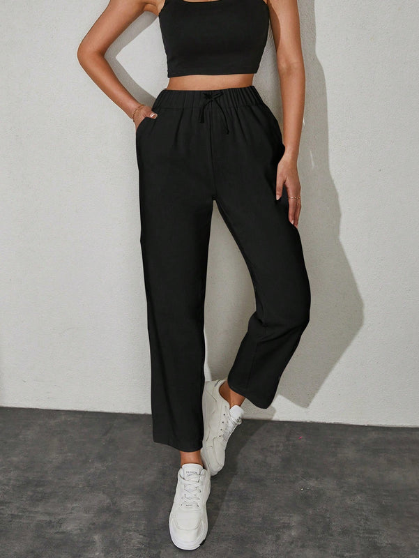 Pantalones unicolor con bolsillo oblicuo de cintura con cordon