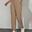 Pantalones unicolor con bolsillo oblicuo de cintura con cordon