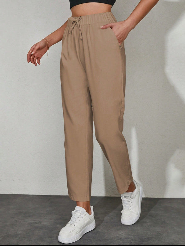 Pantalones unicolor con bolsillo oblicuo de cintura con cordon