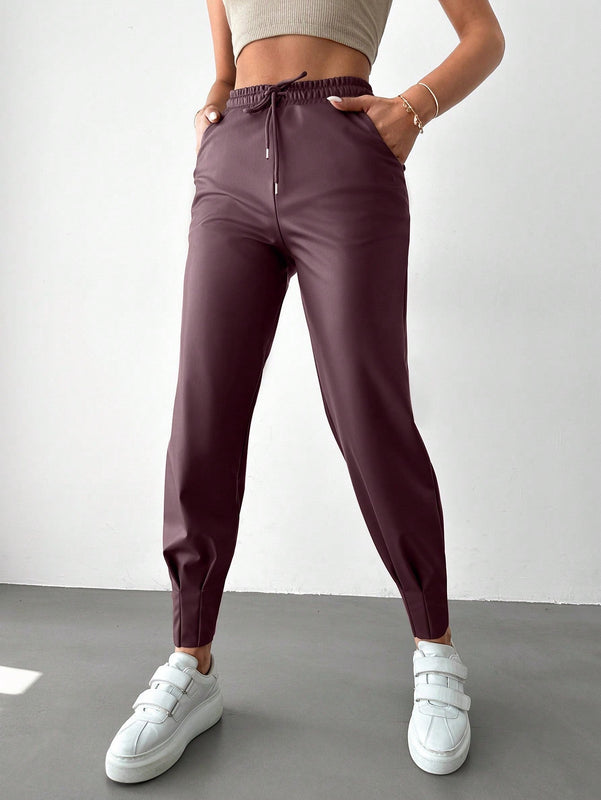 Pantalones con punos elasticos y cintura con cordon de color liso para mujer