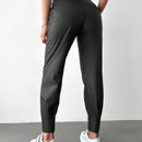 Pantalones con punos elasticos y cintura con cordon de color liso para mujer