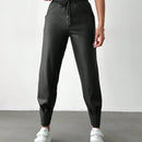 Pantalones con punos elasticos y cintura con cordon de color liso para mujer