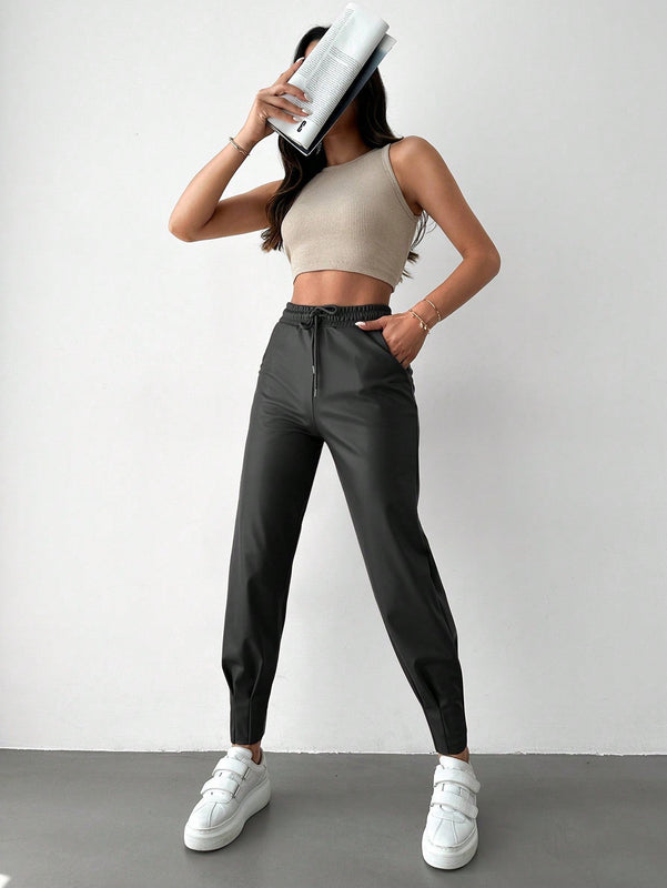 Pantalones con punos elasticos y cintura con cordon de color liso para mujer