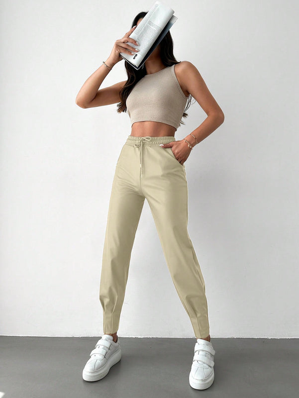 Pantalones con punos elasticos y cintura con cordon de color liso para mujer