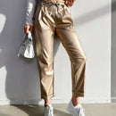 Pantalones largos de tela metalica con nudo frontal para mujer