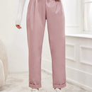 Pantalones largos de tela metalica con nudo frontal para mujer