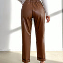 Pantalones largos de tela metalica con nudo frontal para mujer
