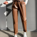 Pantalones largos de tela metalica con nudo frontal para mujer
