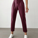 Pantalones largos de tela metalica con nudo frontal para mujer