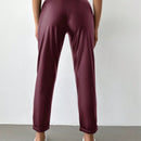 Pantalones largos de tela metalica con nudo frontal para mujer
