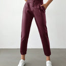 Pantalones largos de tela metalica con nudo frontal para mujer