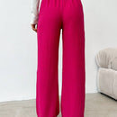 Pantalones sueltos de pierna ancha de color solido para mujer con dobladillo fluido, estilo casual
