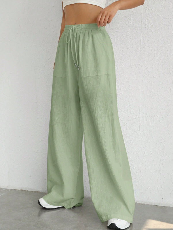 Pantalones sueltos de pierna ancha de color solido para mujer con dobladillo fluido, estilo casual