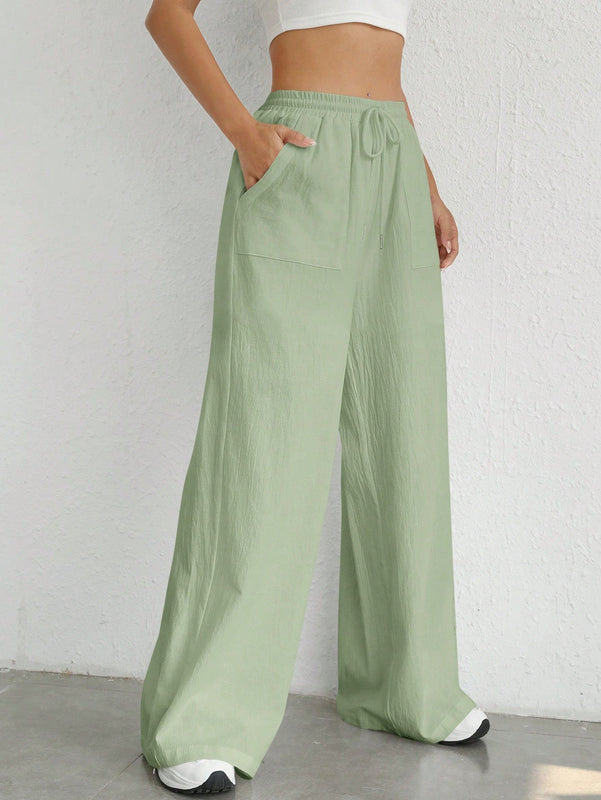 Pantalones sueltos de pierna ancha de color solido para mujer con dobladillo fluido, estilo casual