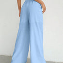 Pantalones sueltos de pierna ancha de color solido para mujer con dobladillo fluido, estilo casual