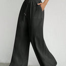 Pantalones sueltos de pierna ancha de color solido para mujer con dobladillo fluido, estilo casual