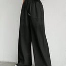 Pantalones sueltos de pierna ancha de color solido para mujer con dobladillo fluido, estilo casual