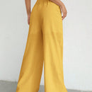 Pantalones sueltos de pierna ancha de color solido para mujer con dobladillo fluido, estilo casual