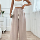 Pantalones boho anchos de vacaciones con bandas elasticas tejidas de rayas y cordon decorativo