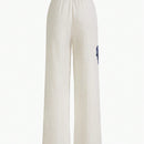 Motf premium pantalones de bolsillo inclinado con estampado floral y costura frontal