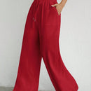 Pantalones sueltos de pierna ancha de color solido para mujer con dobladillo fluido, estilo casual