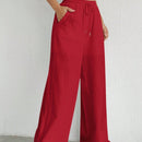 Pantalones sueltos de pierna ancha de color solido para mujer con dobladillo fluido, estilo casual
