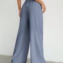 Pantalones sueltos de pierna ancha de color solido para mujer con dobladillo fluido, estilo casual