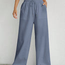 Pantalones sueltos de pierna ancha de color solido para mujer con dobladillo fluido, estilo casual