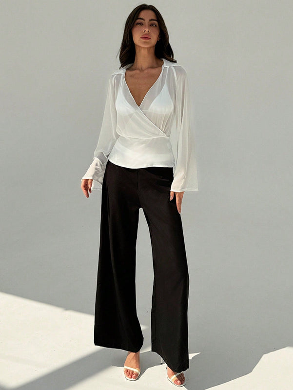 Blusa blanca de mujer con cuello en V profundo transparente, mangas largas abocinadas y munequeras con cintura suelta
