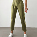 Pantalones largos de tela metalica con nudo frontal para mujer
