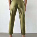 Pantalones largos de tela metalica con nudo frontal para mujer